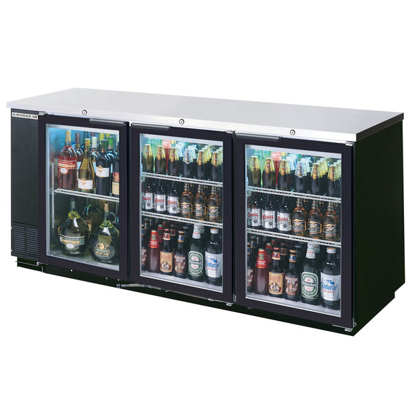 A Beverage-Air black back bar refrigerator with bottles of beer inside.