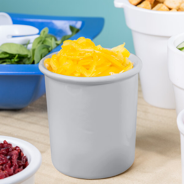 A white container with yellow food in it on a counter.
