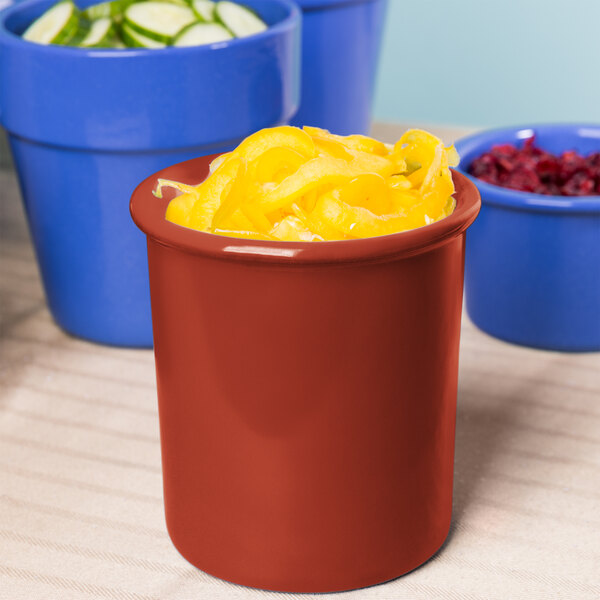 A red Tablecraft condiment bowl with yellow food inside.