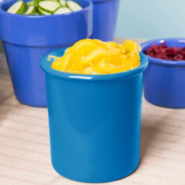 A blue bowl with yellow food inside on a counter.