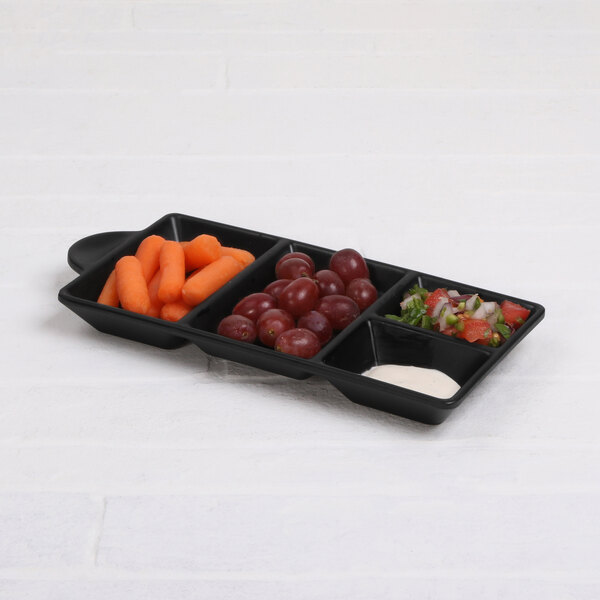 A black Elite Global Solutions melamine tray with four compartments filled with different vegetables.
