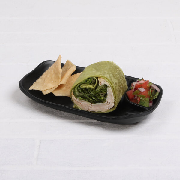 An Elite Global Solutions black melamine two-compartment tray with food on it.