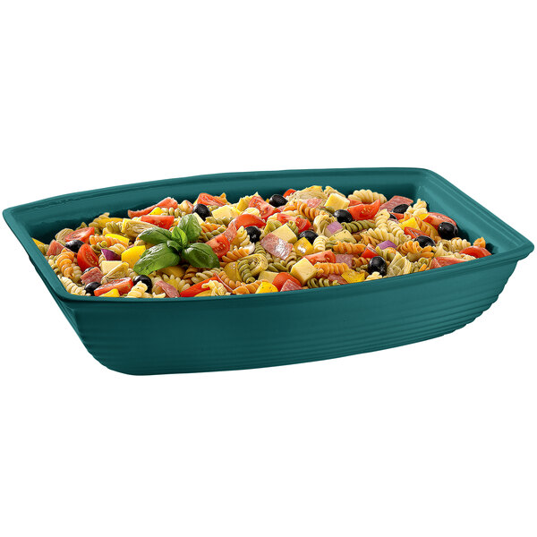 A hunter green Tablecraft cast aluminum oblong bowl filled with pasta salad and vegetables.