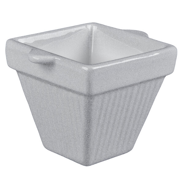 A white square cast aluminum bowl with a handle.