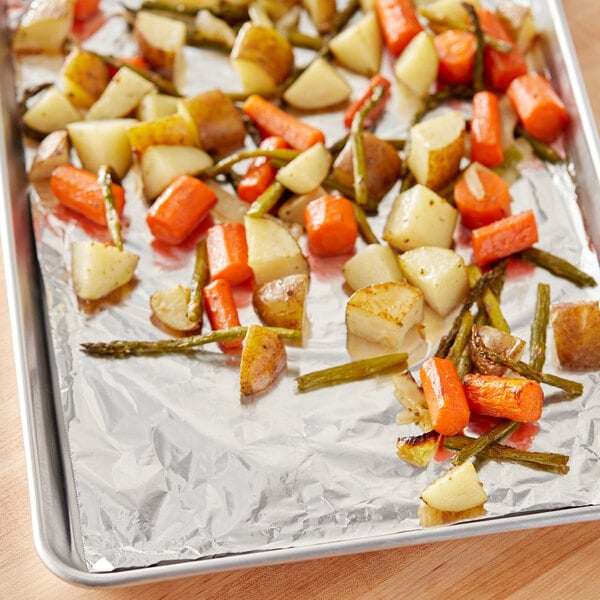 Choice standard aluminum foil wrapped roasted vegetables on a tray.