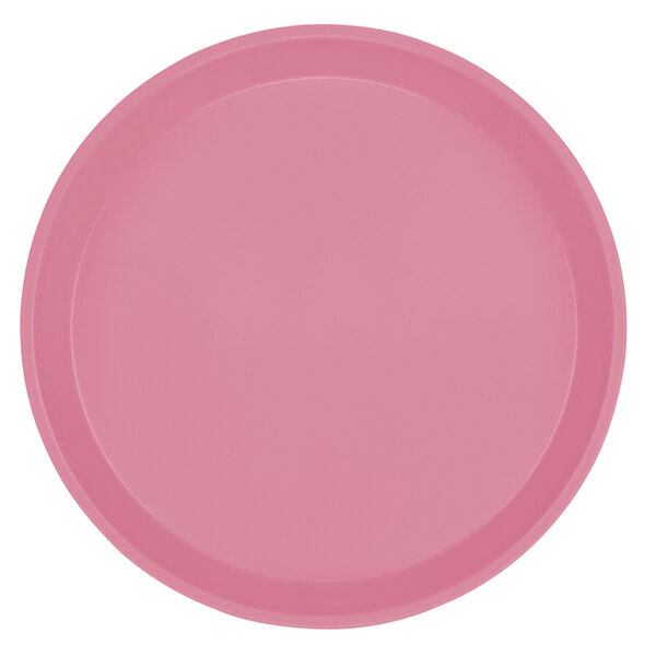 A close-up of a pink Cambro round fiberglass tray with a white background.