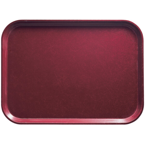 A red rectangular Cambro tray on a white surface.