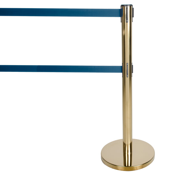 A gold metal stanchion with dual blue retractable belts.