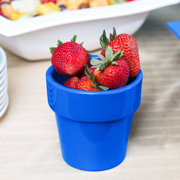 A Tablecraft cobalt blue round condiment bowl filled with strawberries.