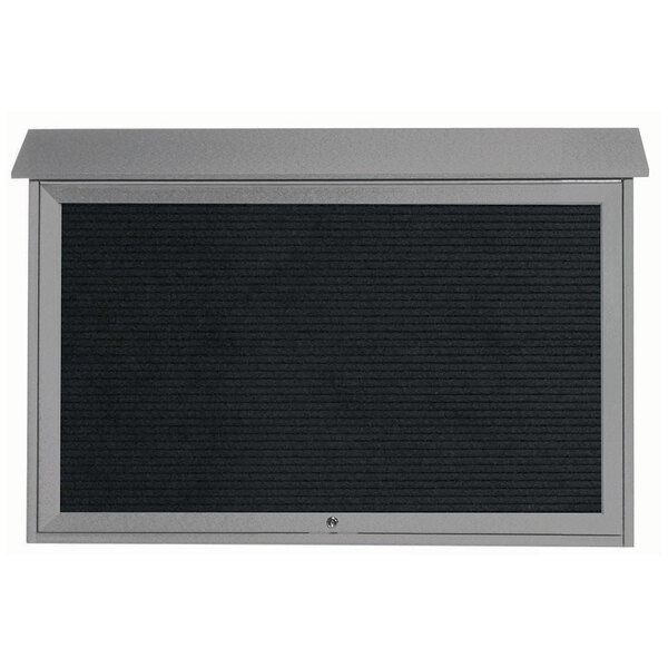 A light gray Aarco message center with a black letter board and black screen.