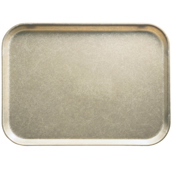 A rectangular desert tan fiberglass Cambro tray on a counter in a school kitchen.