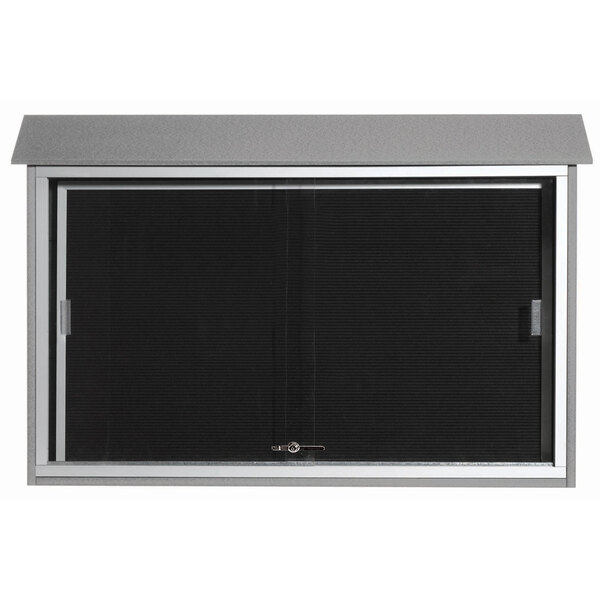 A light gray Aarco outdoor message center with sliding doors and a black letter board.