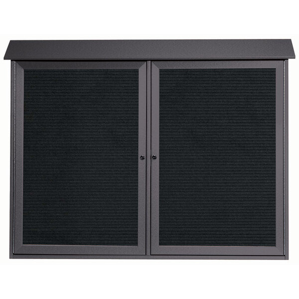 A black cabinet with dual hinged metal doors and a black rectangular message board.