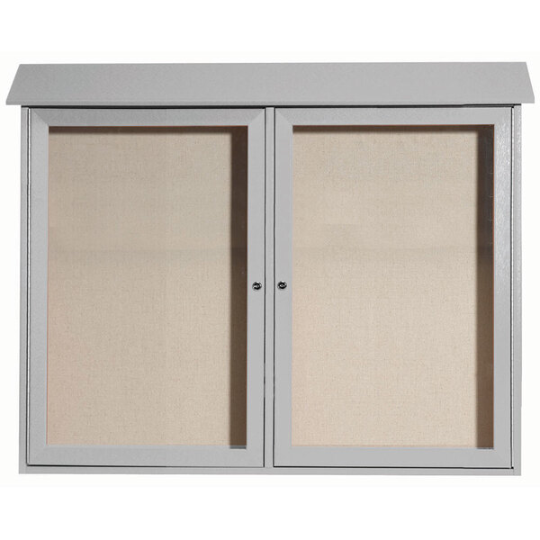 A white cabinet with Aarco vinyl tackboard doors.
