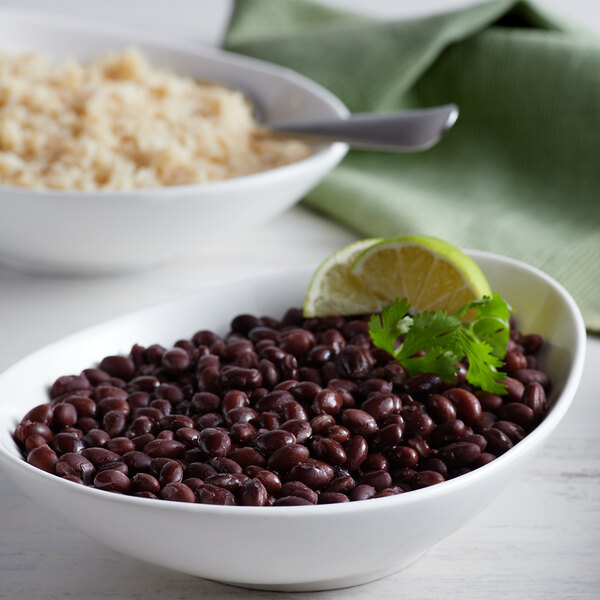 A bowl of Furmano's black beans with rice and a spoon.