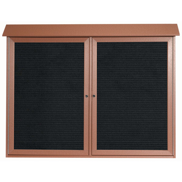 A brown framed bulletin board with black letter boards.