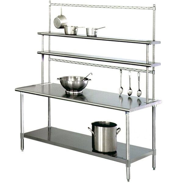 A stainless steel Eagle Group work table with a Flex-Master overshelf and pot racks holding pots and pans.