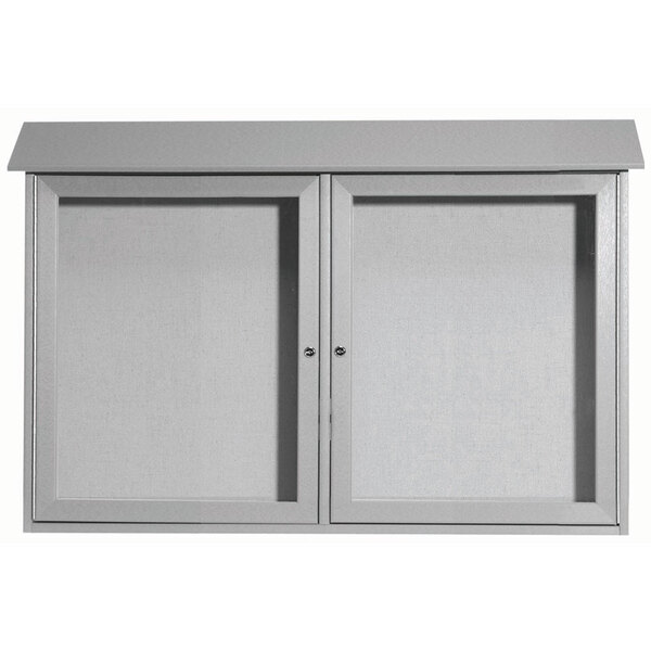A white Aarco cabinet with black vinyl tackboard doors.