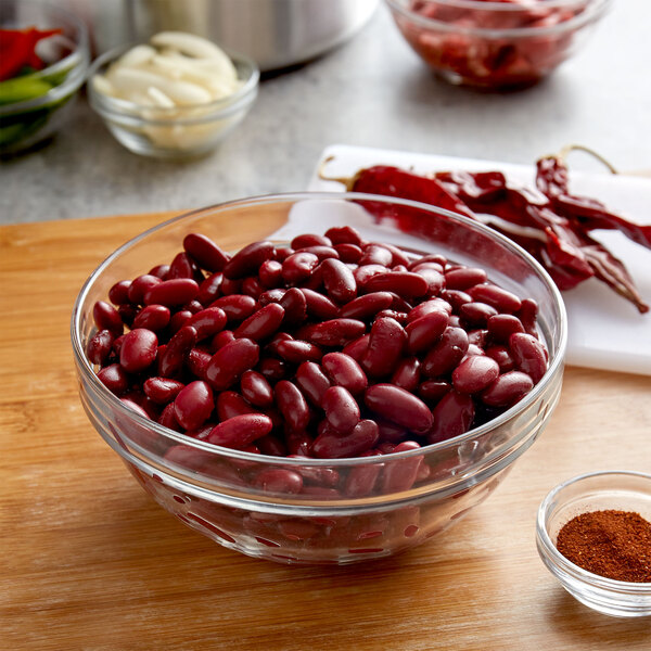 A bowl of Furmano's organic dark kidney beans with spices on a table.