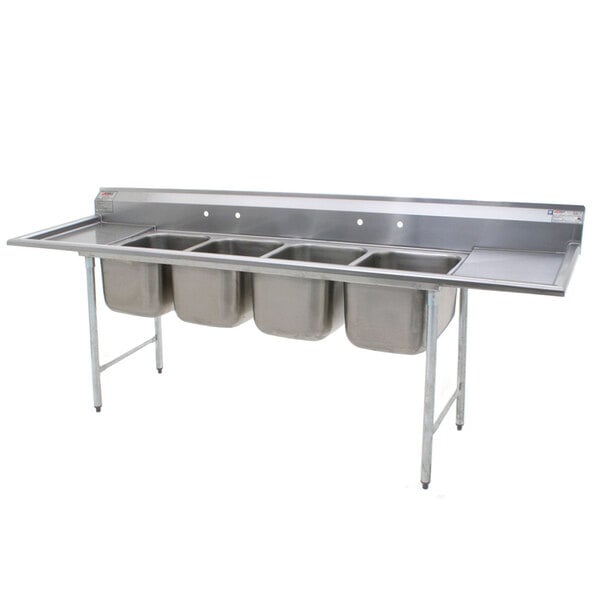 A stainless steel Eagle Group 4 compartment sink with two drainboards.