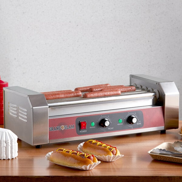 A Grand Slam hot dog roller grill with hot dogs cooking.