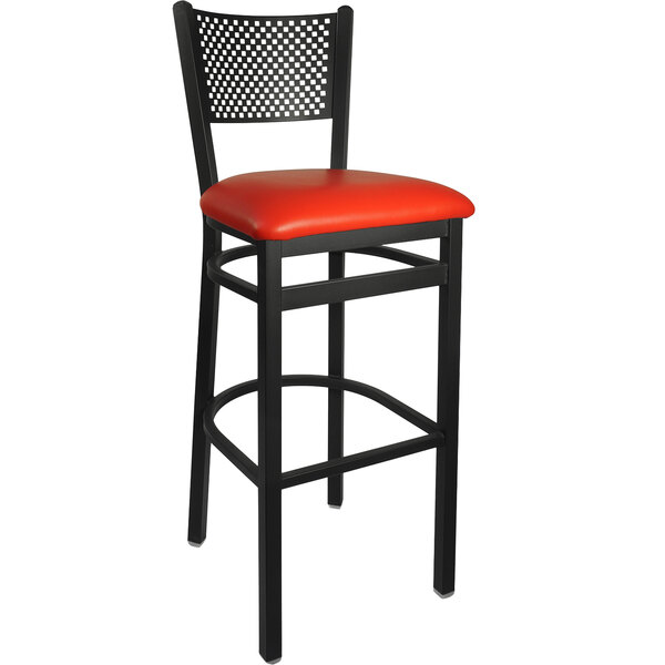 A BFM Seating black steel bar stool with a red vinyl seat.