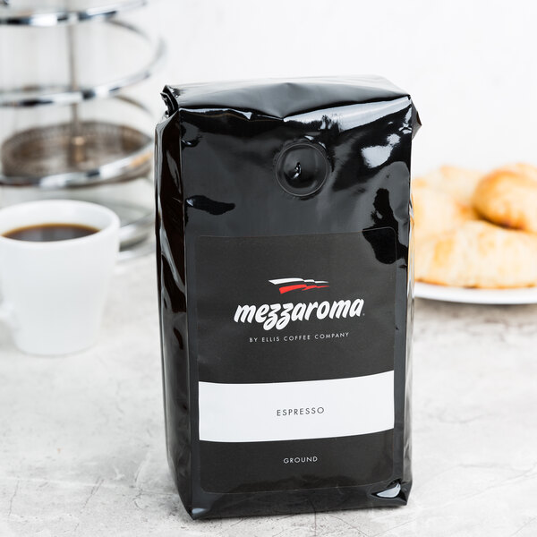 A black bag of Ellis Mezzaroma Dark Regular Ground Espresso with a white label.
