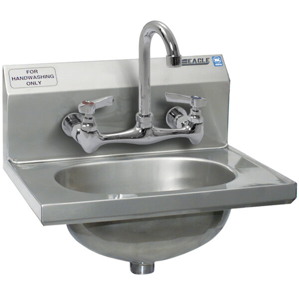 A close-up of a stainless steel Eagle Group hand sink with two faucets.