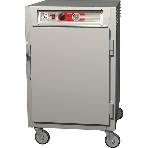 A stainless steel Metro C5 half-height reach-in holding cabinet with wheels and solid doors.