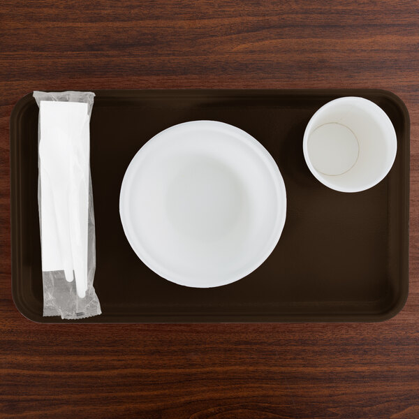 A brown Cambro tray with a white plate and cup on it.