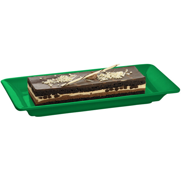 A Tablecraft green cast aluminum rectangular platter holding a rectangular piece of chocolate cake.
