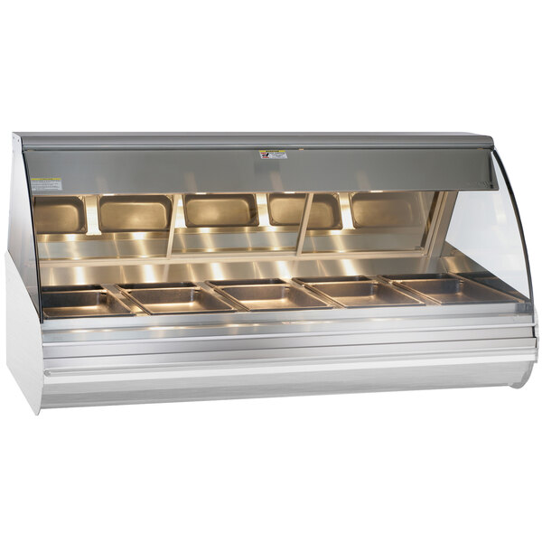 An Alto-Shaam stainless steel countertop heated display case with curved glass over food trays.