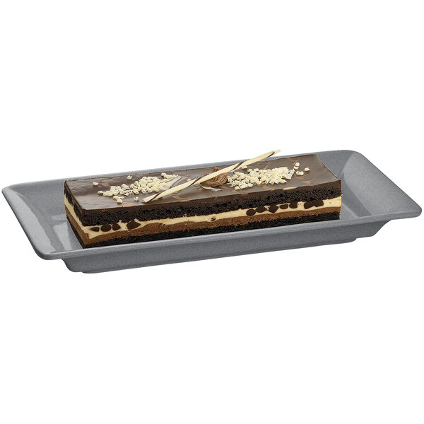 A rectangular chocolate cake on a Tablecraft granite cast aluminum platter.