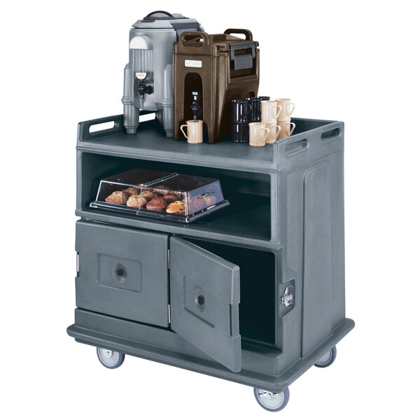 A grey Cambro meal delivery cart with a door open and food on top.