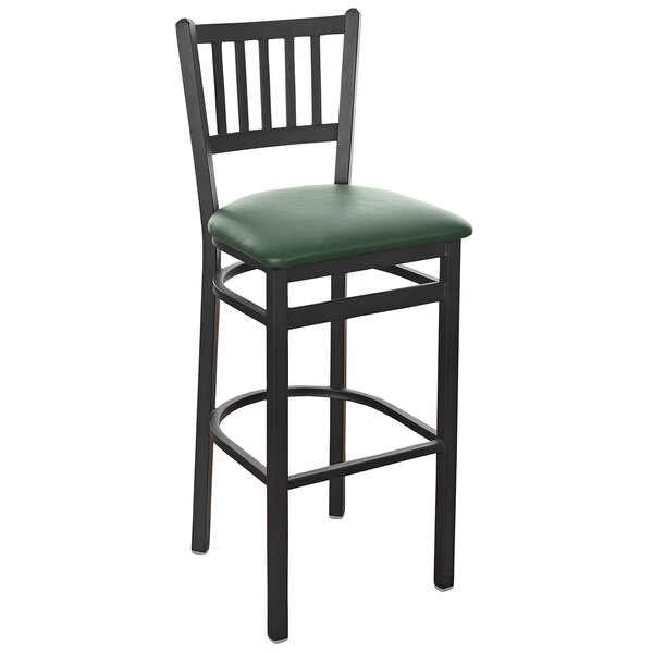 A BFM Seating black steel restaurant bar stool with a green vinyl seat.
