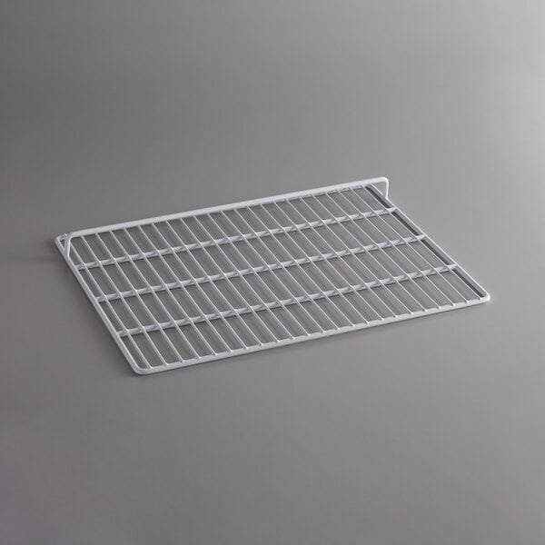 A white metal rack on a gray surface.