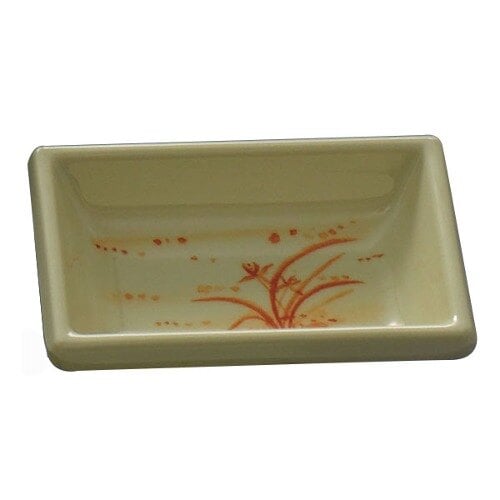 A rectangular white dish with a gold floral design.