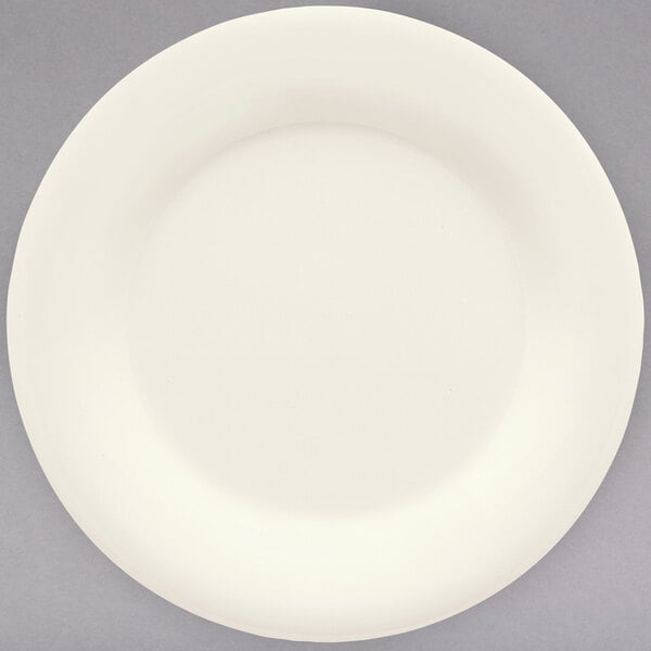 A white plate with a white rim on a gray background.