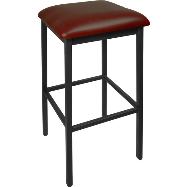 A BFM Seating black steel barstool with a burgundy vinyl seat.