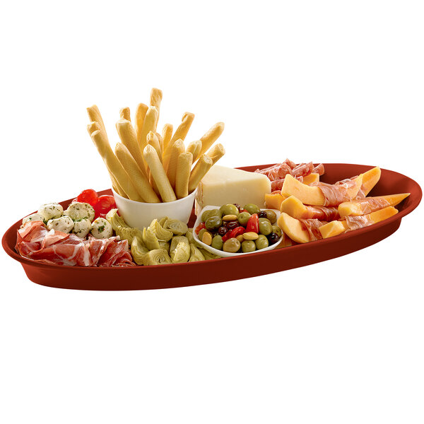 A Tablecraft copper cast aluminum platter with food on it, a bowl of french fries, and a bowl of olives.