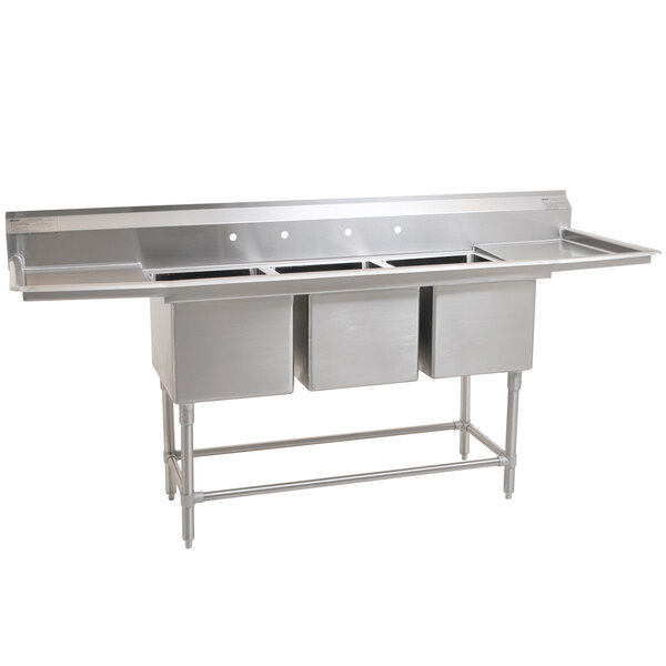 An Eagle Group stainless steel 3 compartment sink with two drainboards.