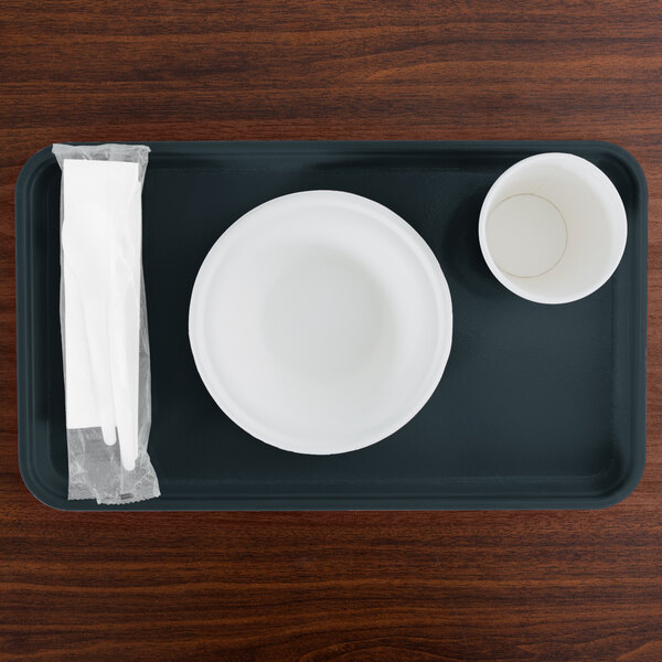 A rectangular slate blue Cambro fiberglass tray with a white bowl and cup on it.