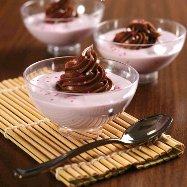 A close-up of chocolate pudding in a clear Fineline Tiny Temptations bowl.