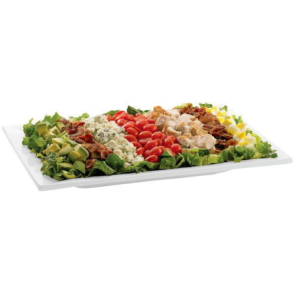 A Tablecraft white cast aluminum rectangular platter with a salad topped with chicken, tomatoes, and lettuce.