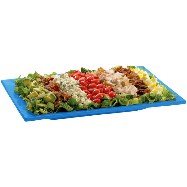 A blue Tablecraft rectangular platter with a salad on it.