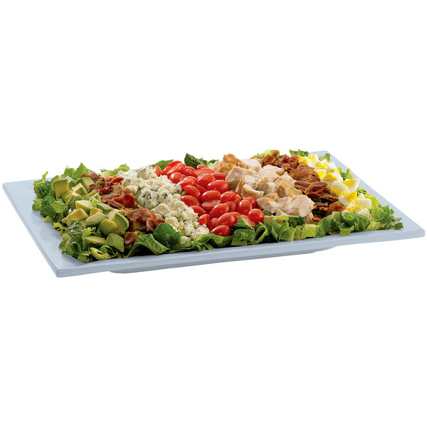 A Tablecraft gray rectangular cast aluminum serving platter with a salad topped with chicken, tomatoes, and lettuce.
