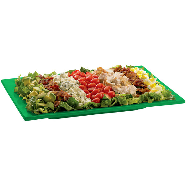 A green Tablecraft rectangular platter with a salad on it.