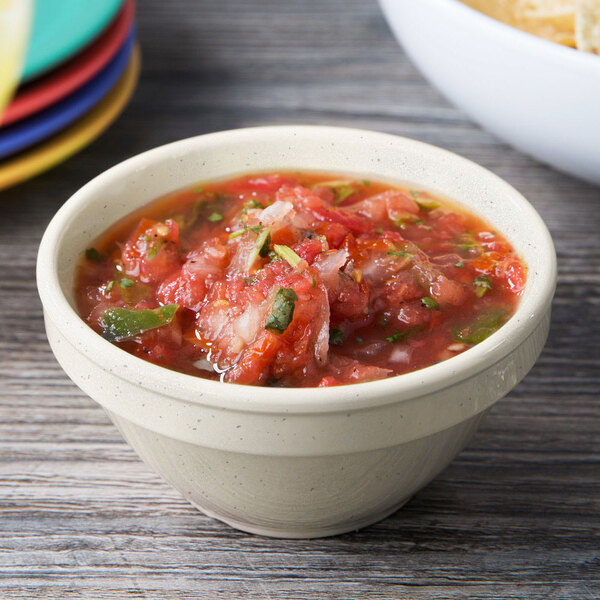 A Santa Fe Ironstone bowl filled with salsa on a table.