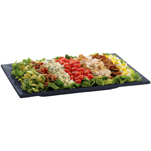 A Tablecraft midnight blue speckle rectangular platter with a salad, chicken, tomatoes, and other ingredients.