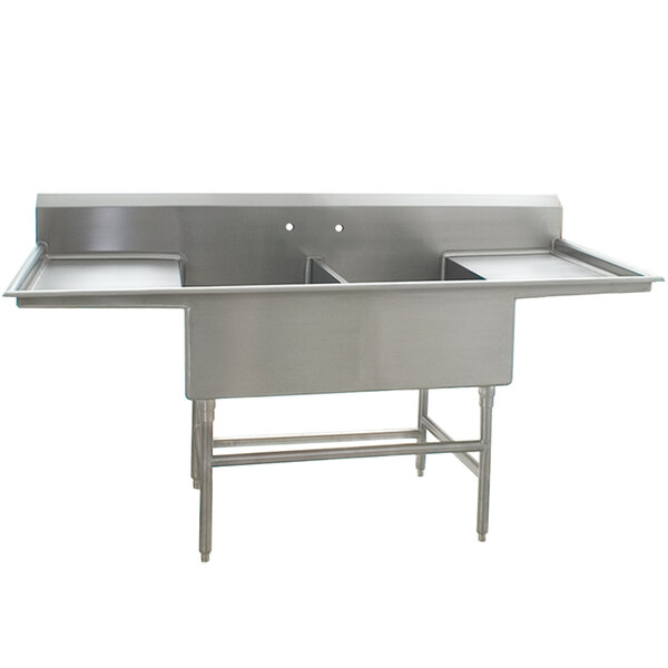 A stainless steel Eagle Group commercial compartment sink with two sinks and two drainboards.